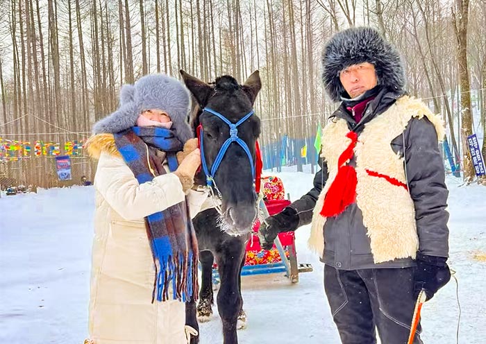 AOT guests enjoying a horse-drawn sleigh ride in Yabuli